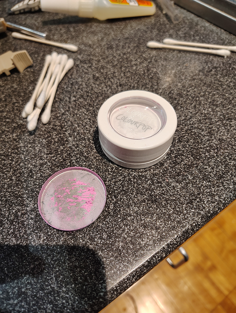 A deconstructed ColourPop super shock blush container. The metal pan has been removed.