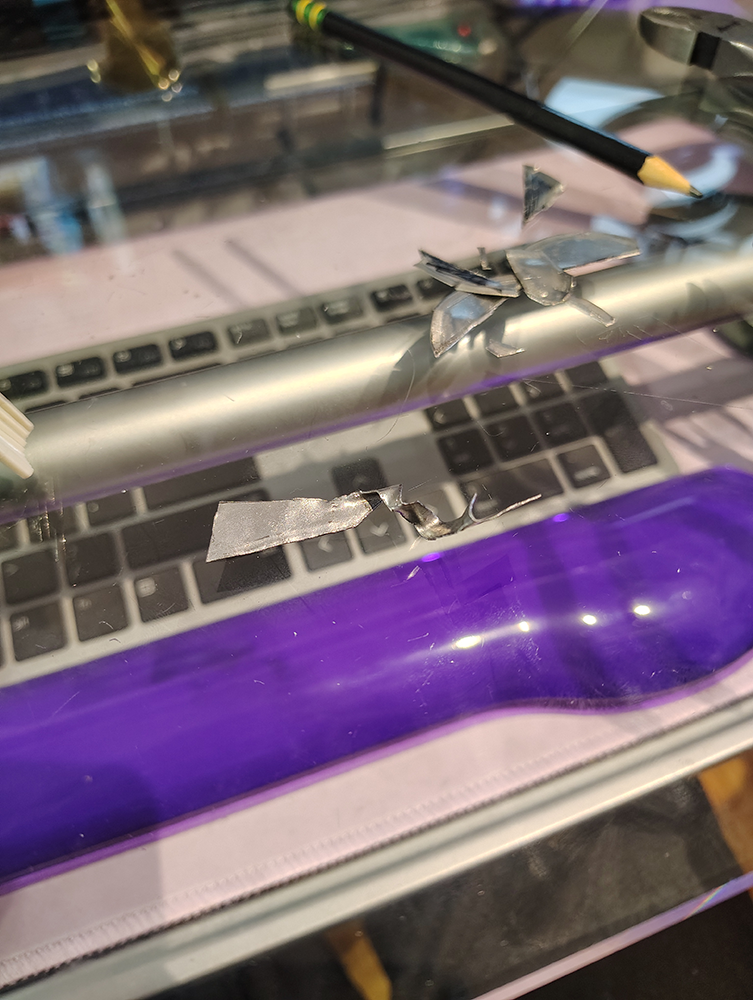 A mangled piece of metal that's about to be hammered in the shape I want.