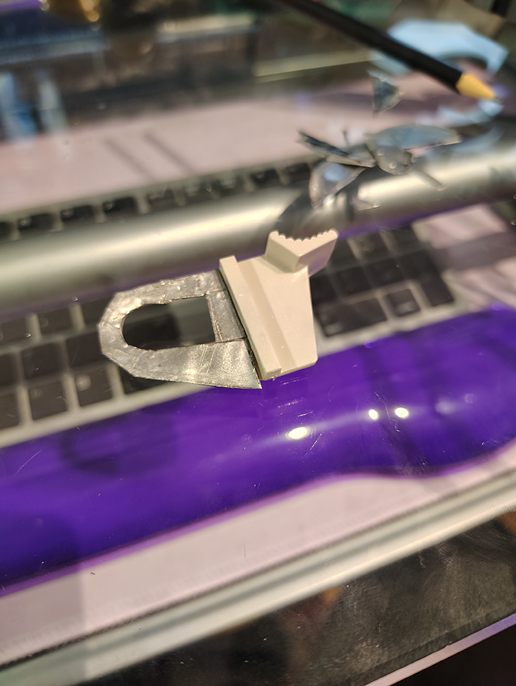 The metal support now in the rough shape of the loop and glued on.