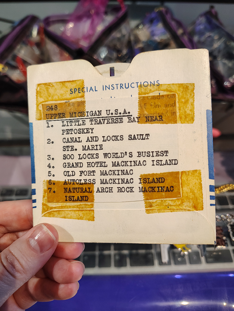 A reel of photos from Upper Michigan with the previous owner's typed listing on the back.